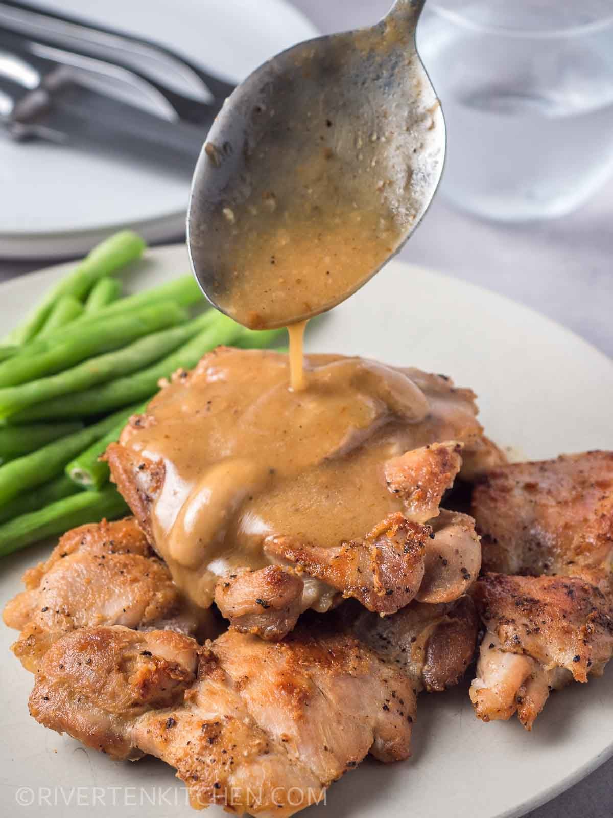 Pan-fried chicken thighs topped with mushroom gravy