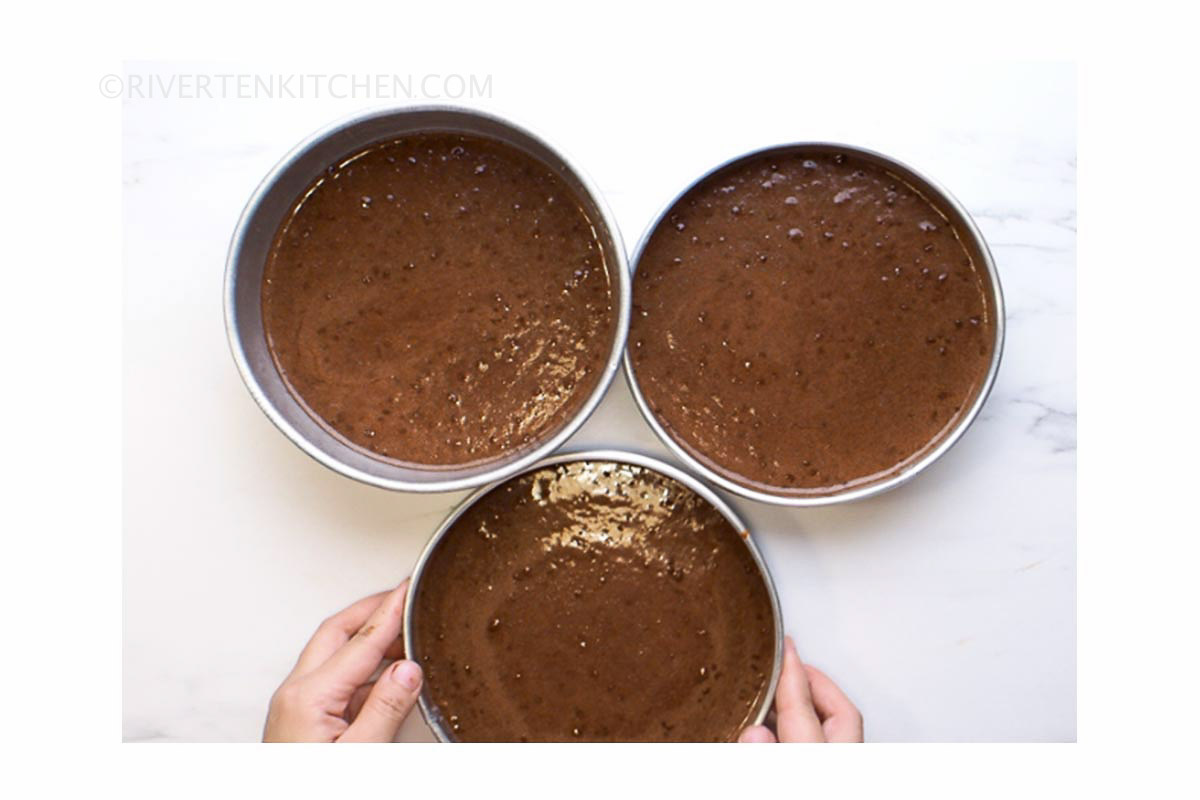 chocolate cake batter in round pans