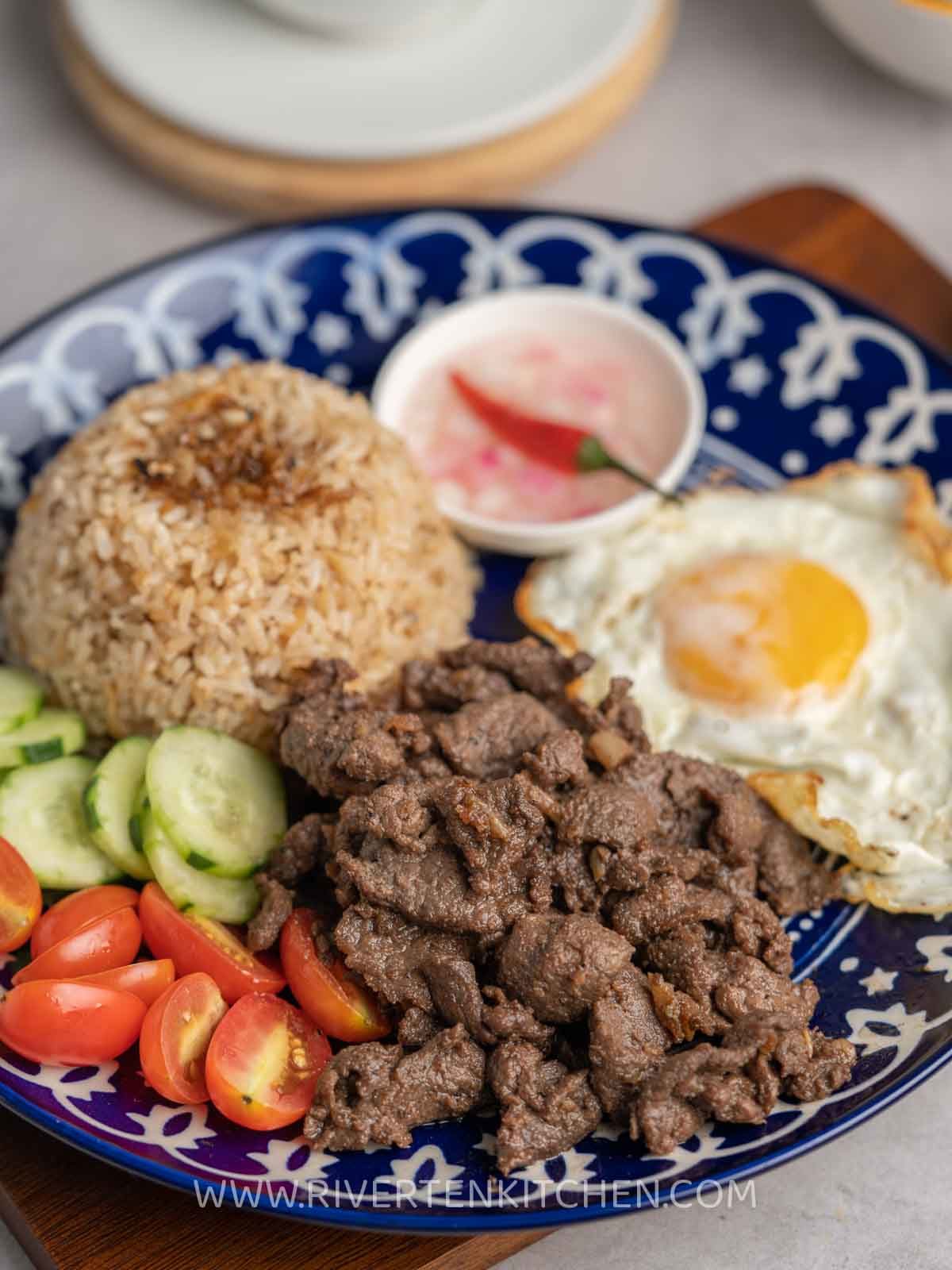 Filipino fried beef with egg and garlic rice