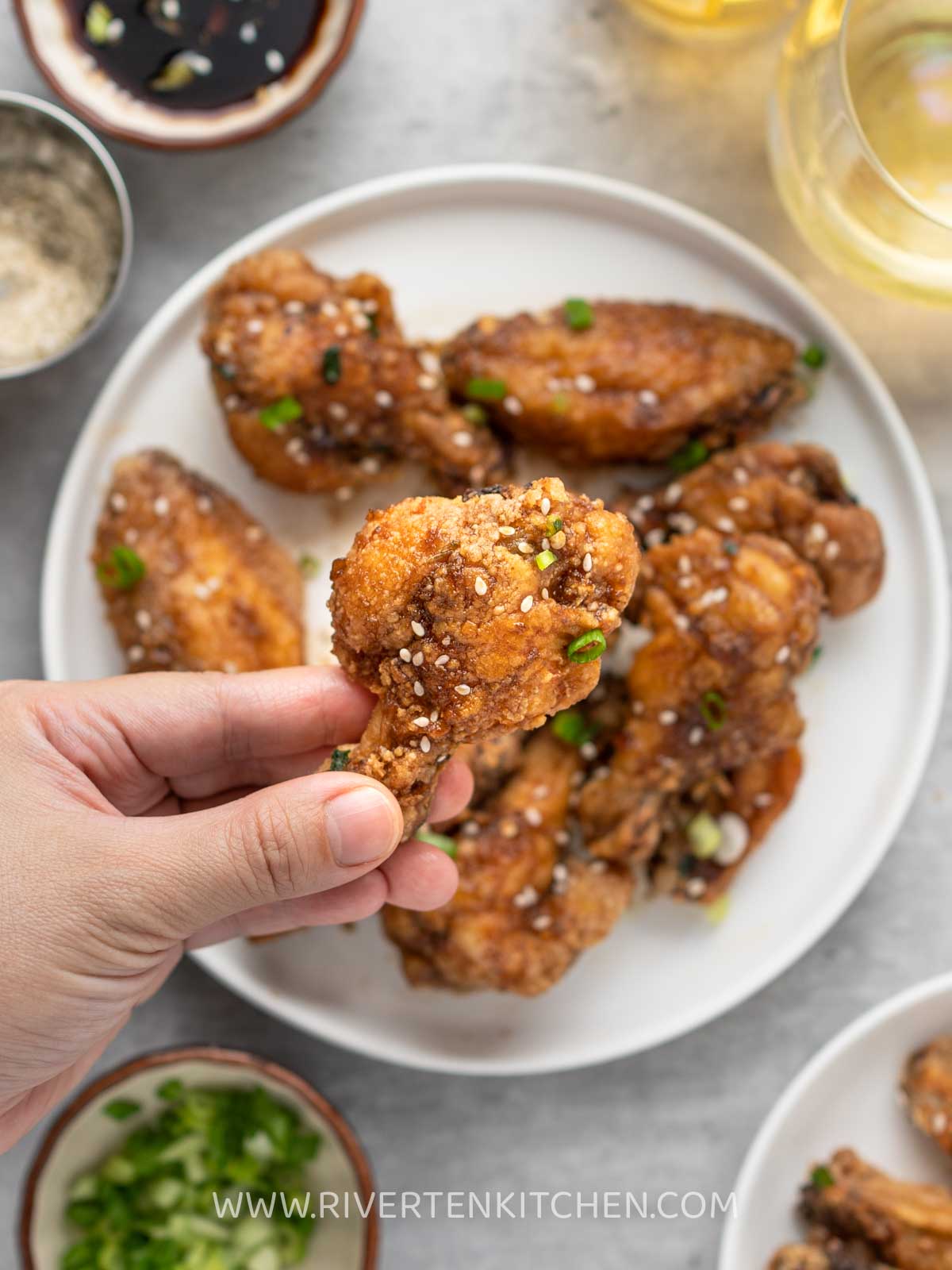 hands holding chicken wings