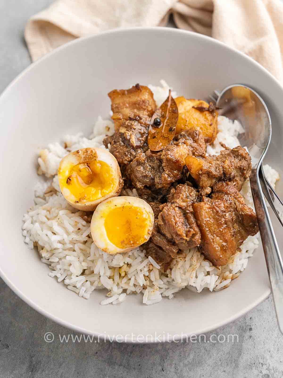 Filipino pork adobo with rice, eggs and potatoes