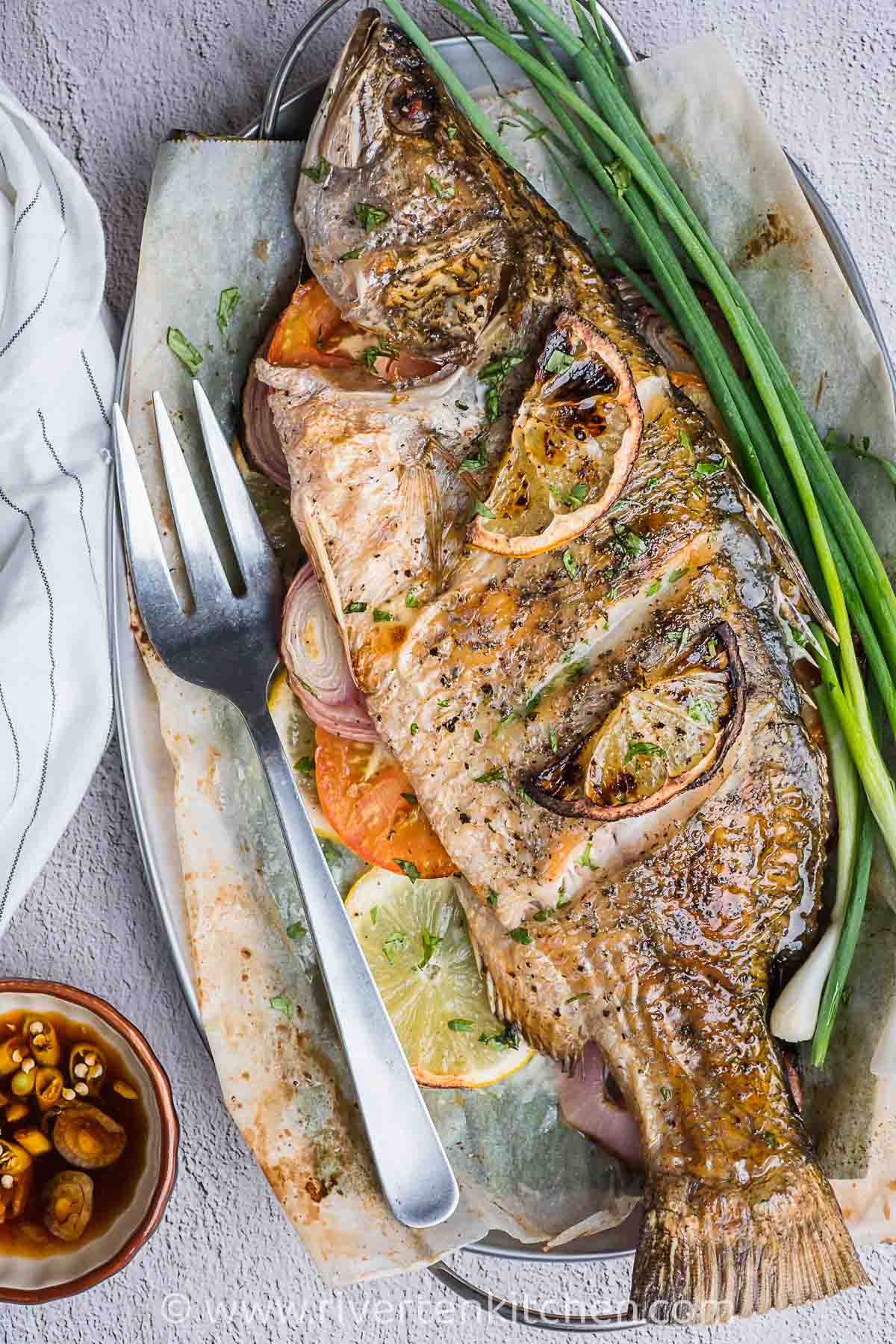 whole fish cooked in an oven. Filled with tomatoes and onion.