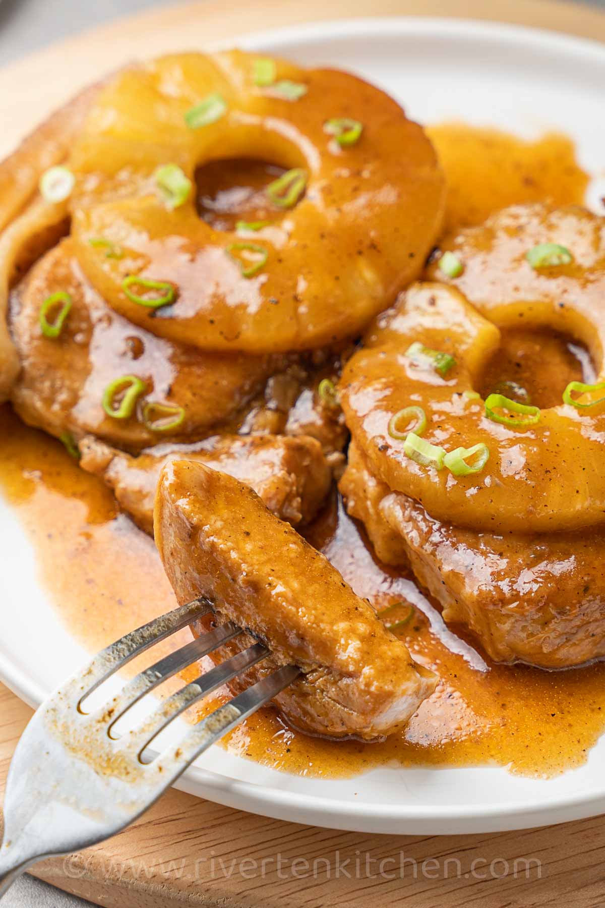 Pork chops with pineapple sauce and pineapple slices cooked in an Instant Pot pressure cooker.