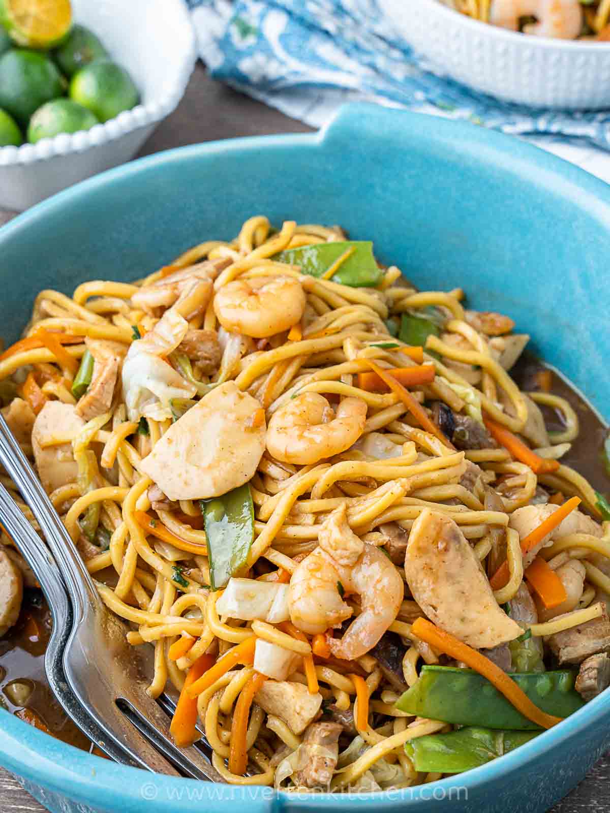 Stir-fried yellow noodles called pancit canton with shrimp, pork and vegetables.