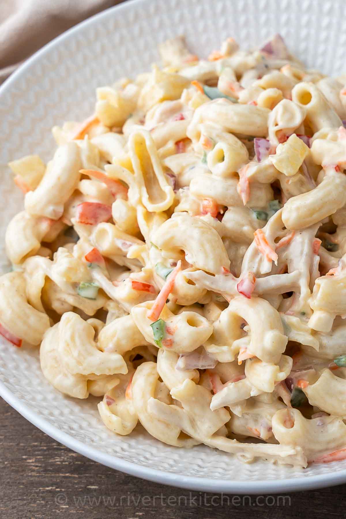 chicken pasta salad with creamy dressing and vegetables.