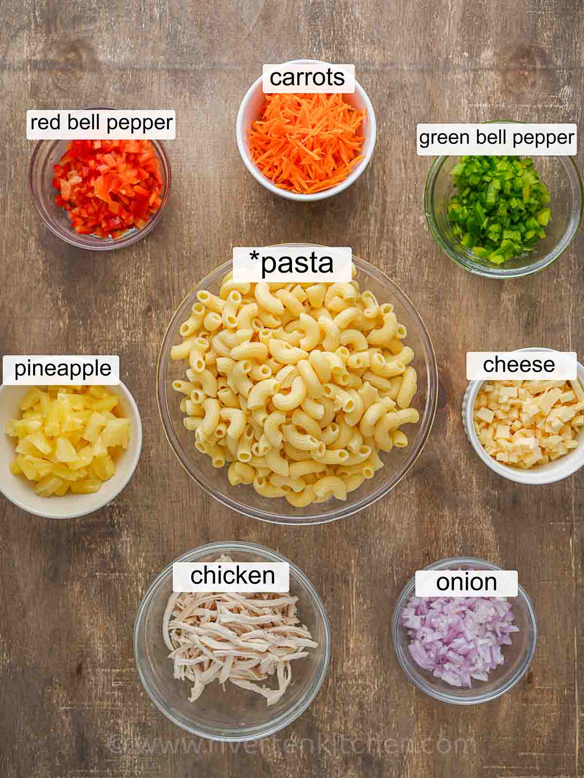 pasta, carrots, shredded chicken, onion, red bell pepper, green bell pepper, pineapple, cheese