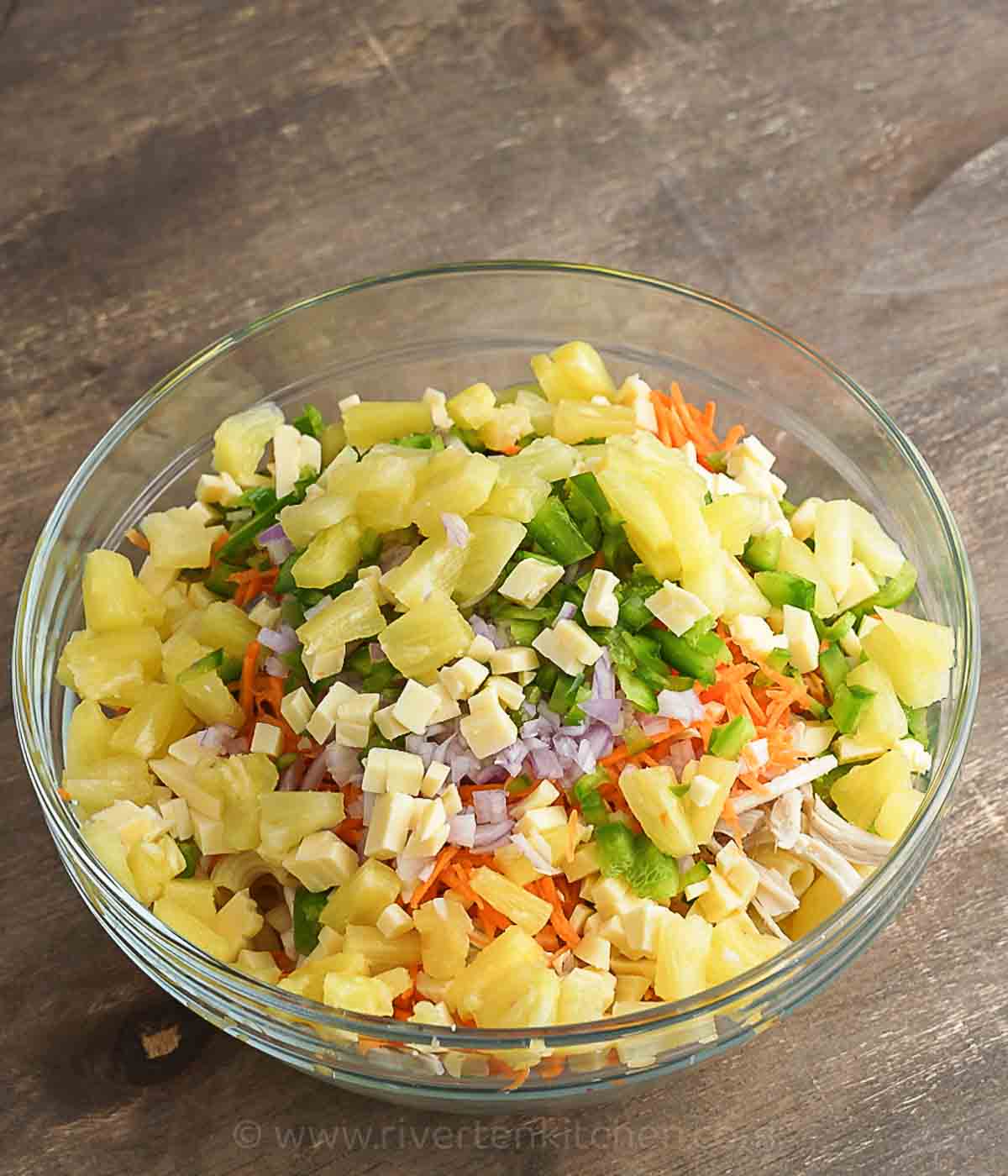 chicken pasta salad ingredients in a large bowl.