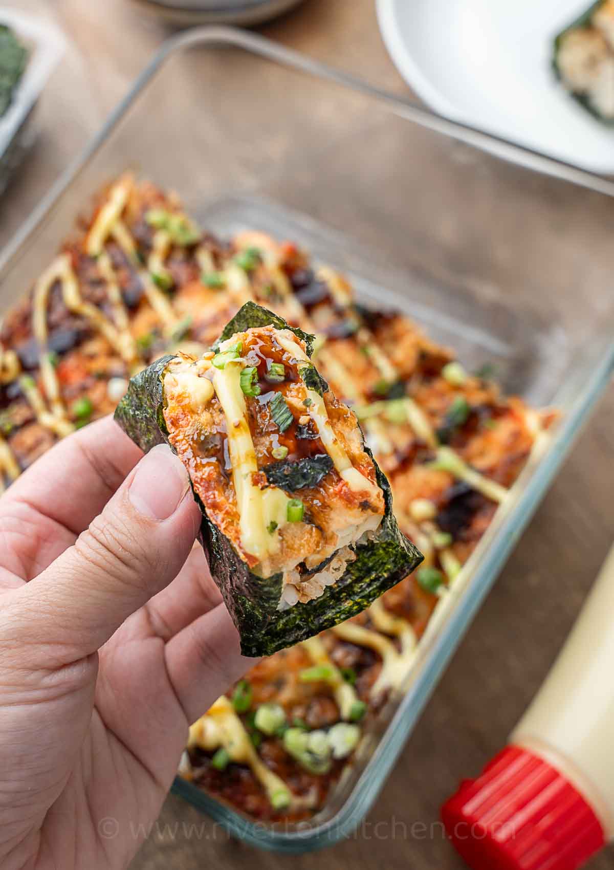 baked sushi with salmon and imitation crab in nori wrap.