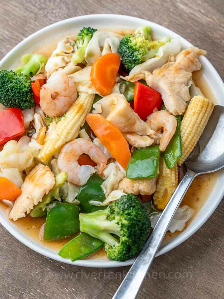 Filipino vegetable stir-fry called chop suey made with shrimp, chicken, cabbage, baby corn, broccoli and cauliflower.