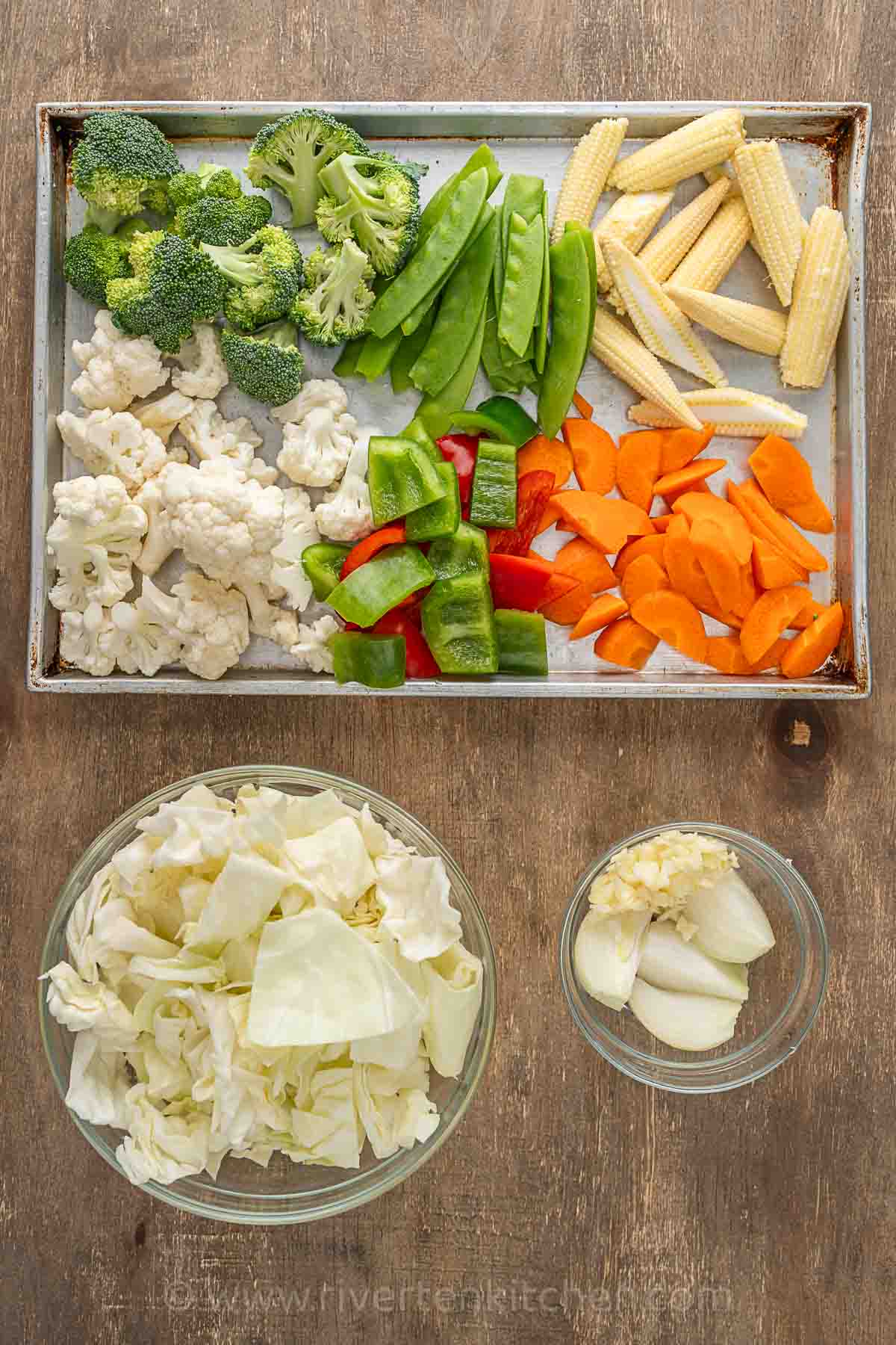 vegetables: cauliflower, broccoli, baby corn, bell pepper, cabbage and carrots.