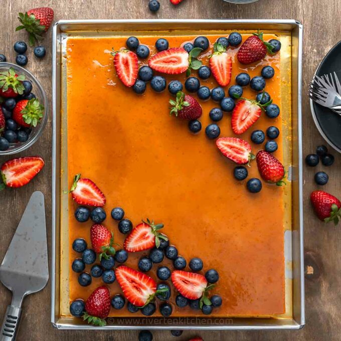 custard cake made of flan and chiffon cake topped with blueberries and strawberries.