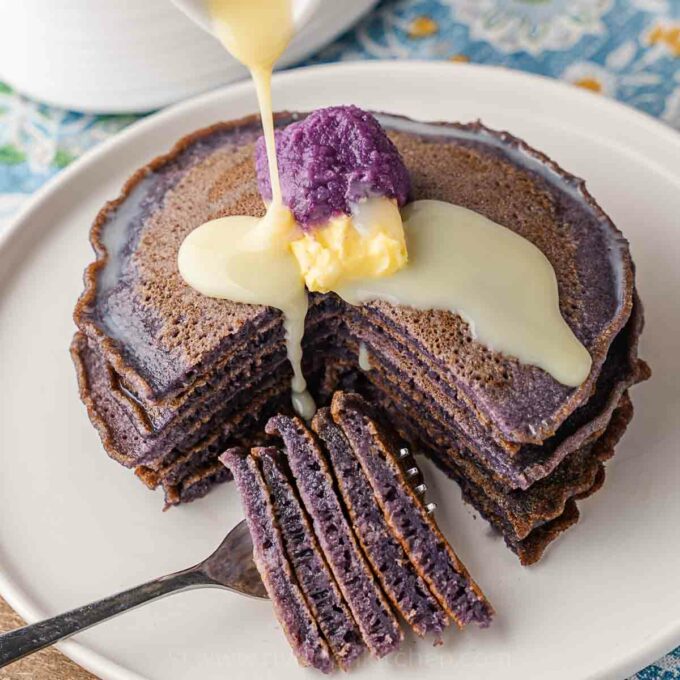ube pancakes drizzled with condensed milk.