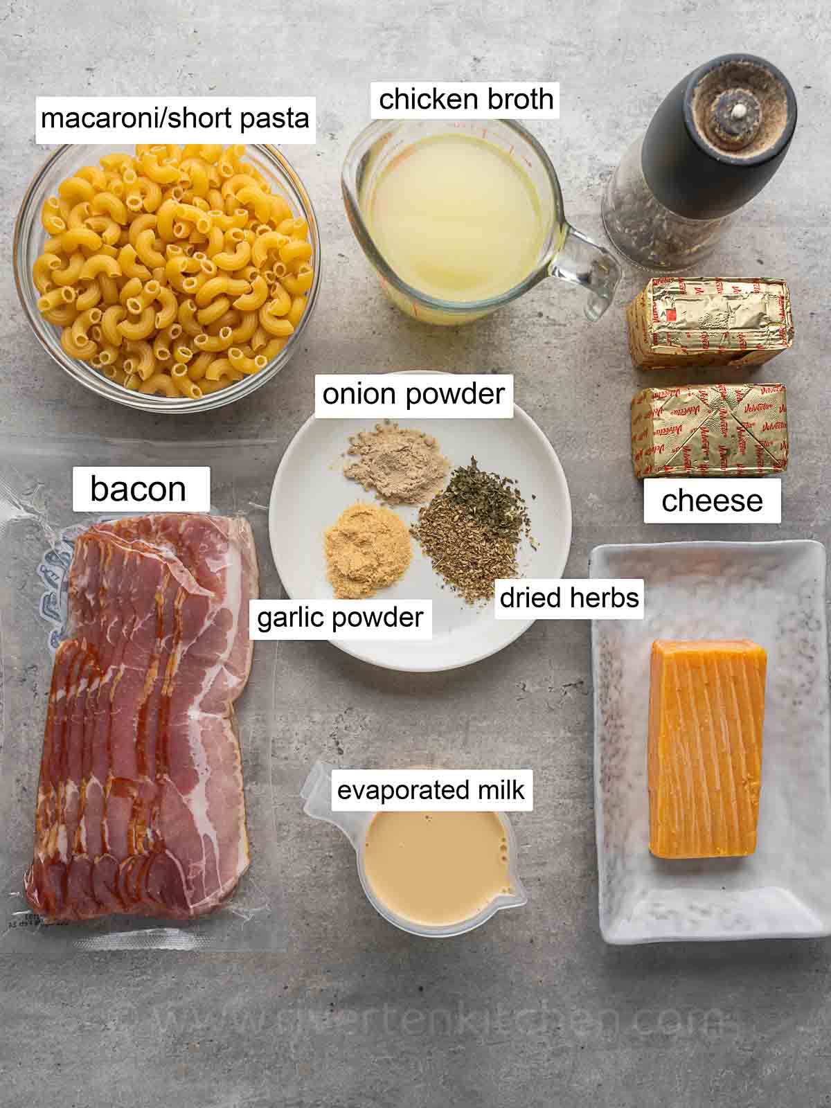 macaroni pasta, chicken broth, streaky bacon, velveeta cheese, evaporated milk, onion powder, garlic powder, and dried herbs.