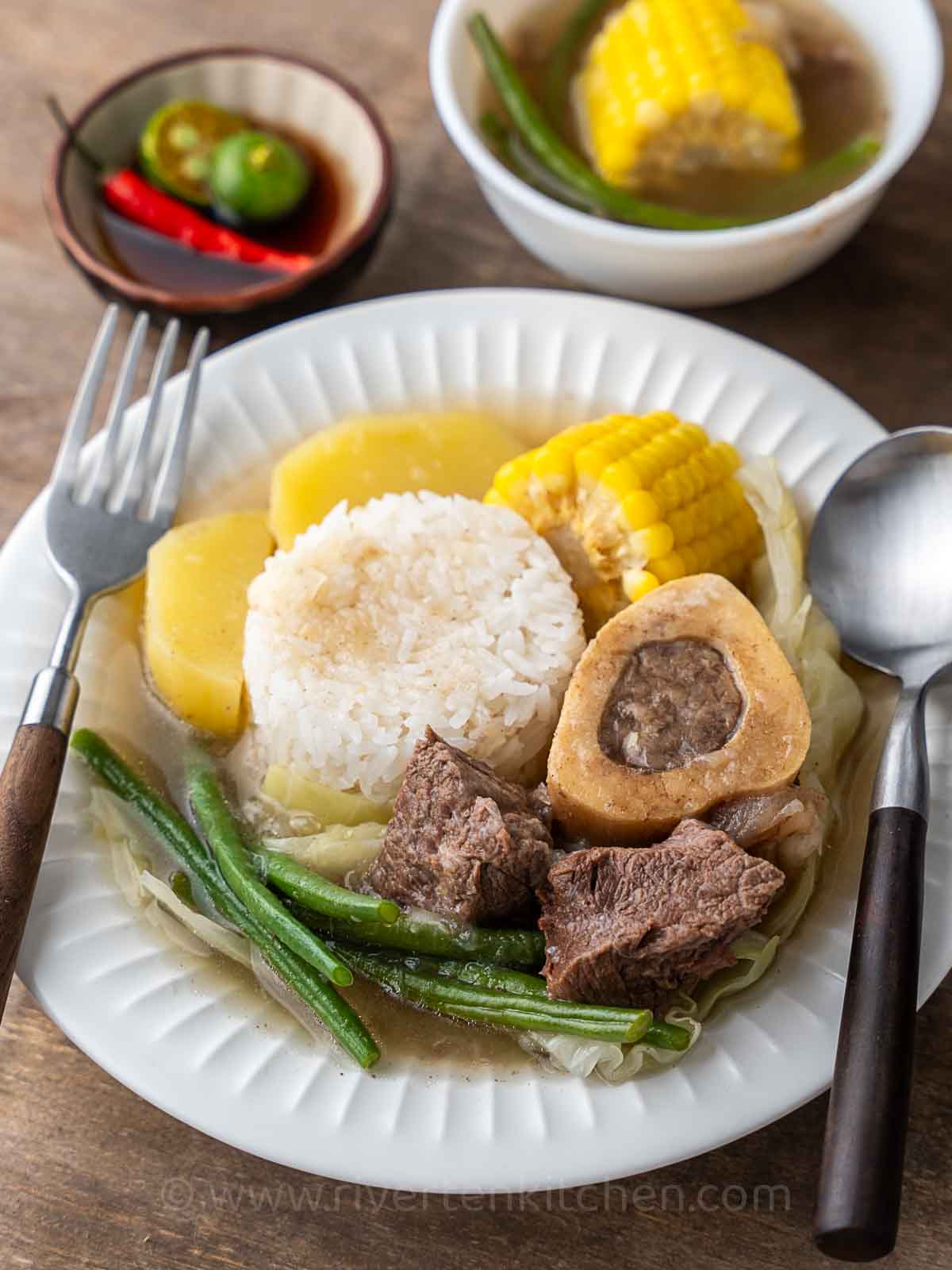 Beef bone soup served with rice and vegetables.