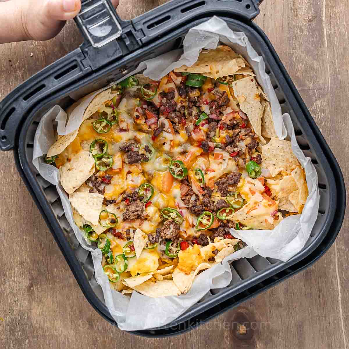 beef nachos with cheese, salsa and jalapenos cooked in an air fryer.