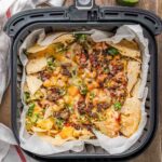 nachos with ground beef and shredded cheese cooked in an air fryer.