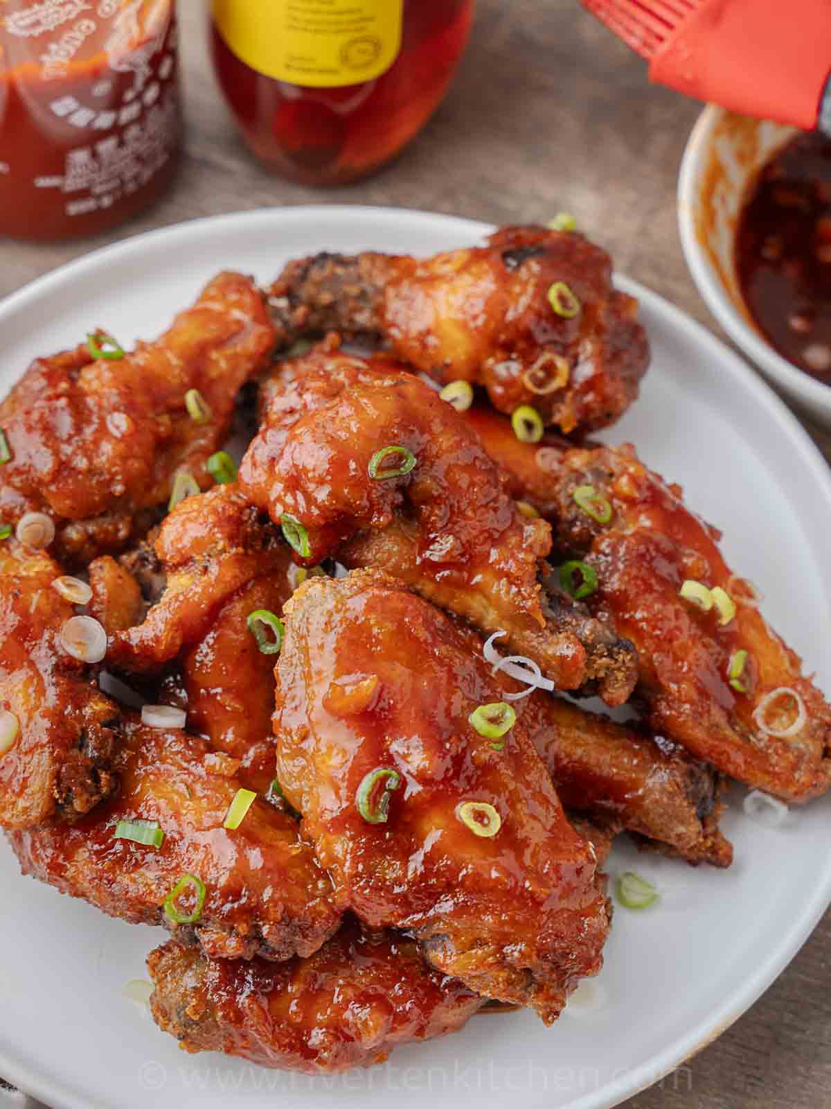 crispy chicken wings coated in honey sriracha sauce.