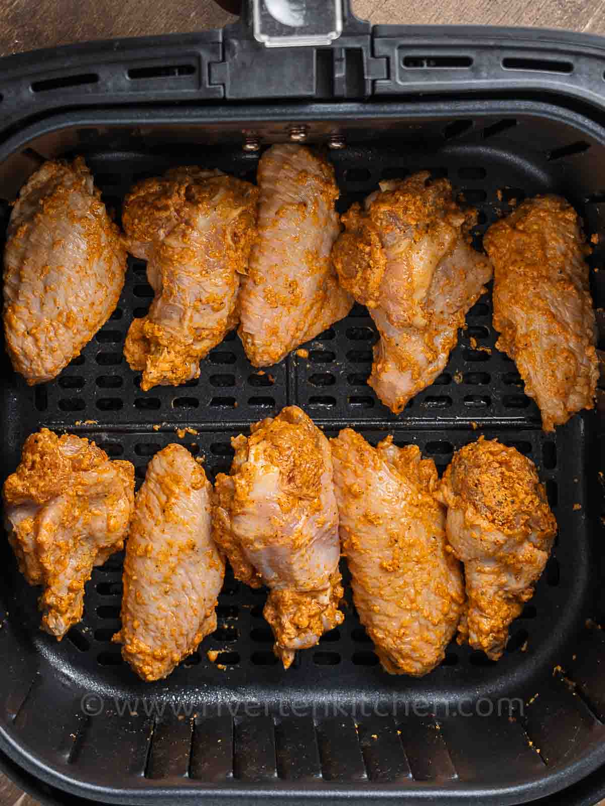 chicken wings coated in seasonings.