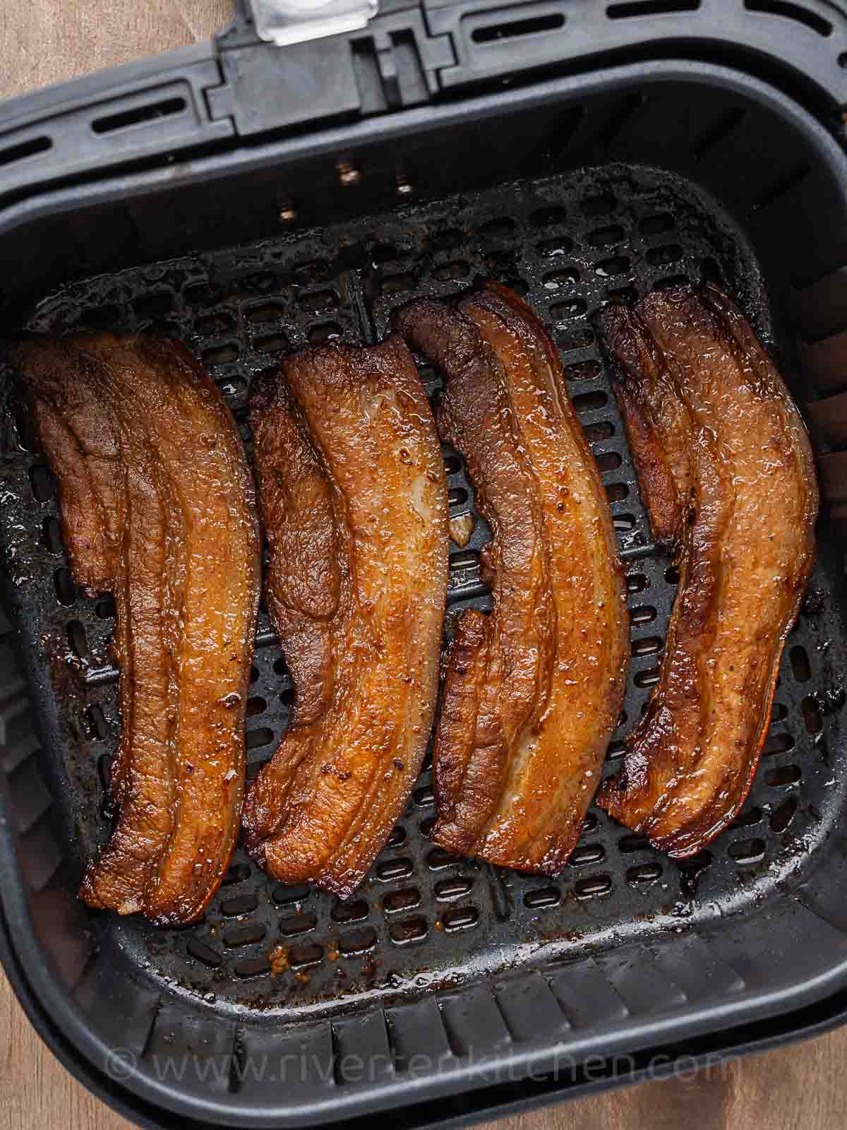 thin slices of marinated pork belly cooked in an air fryer.