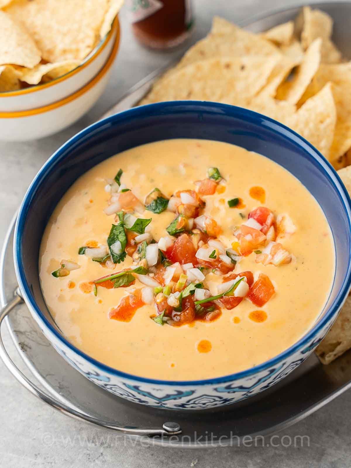 Mexican cheese dip made with velveeta and rotel served with Nachos.