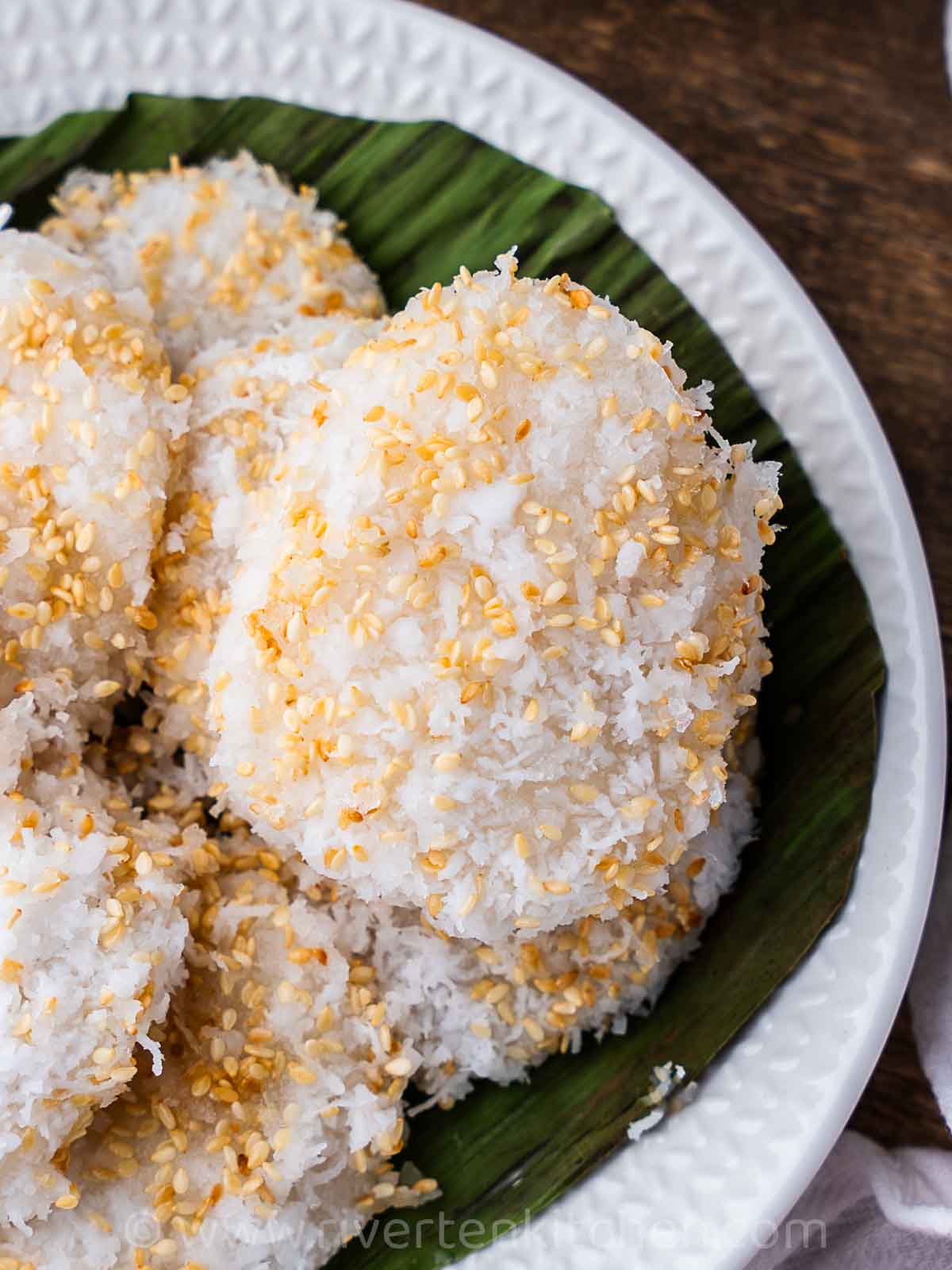 palitaw glutinous rice cakes with coconut, sugar and sesame seeds.